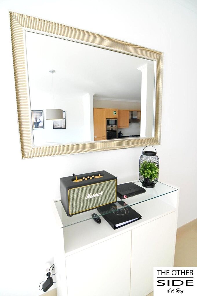 Living room detail: speaker and large mirror